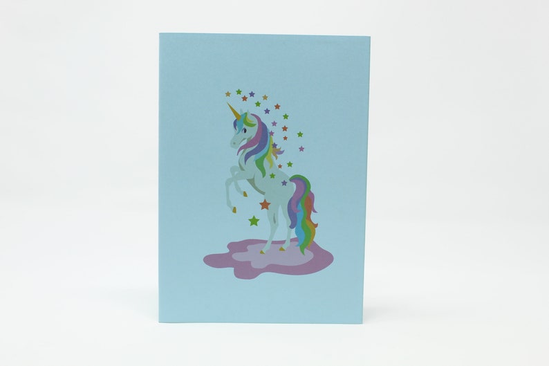 Unicorn pop-up card open showing rainbow bridge