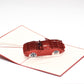 Pop-up card with red convertible car in the middle