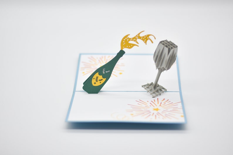 Champagne bottle and glasses pop-up card open