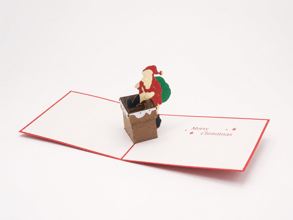 Santa Comes Down the Chimney 3D pop-up card by PopJoy Cards - open view, studio shot