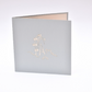 Light grey card with Ferris wheel etched in white