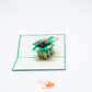 Pop-up card showing garden box lined with picket fence and filled with bright dandelions
