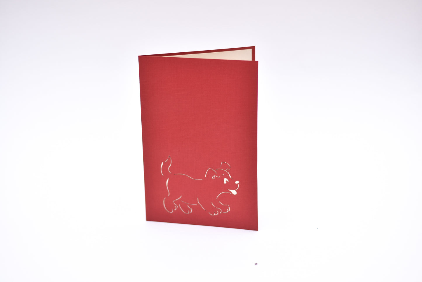 Red card with white dog outline on front cover