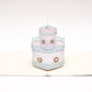 Pop-up card showing two-tiered white birthday cake with blue and pink decor.