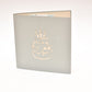 Light grey card with outline of birthday cake with candles on the front cover