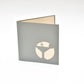 Grey card with silhouette of martini glass in white on front cover
