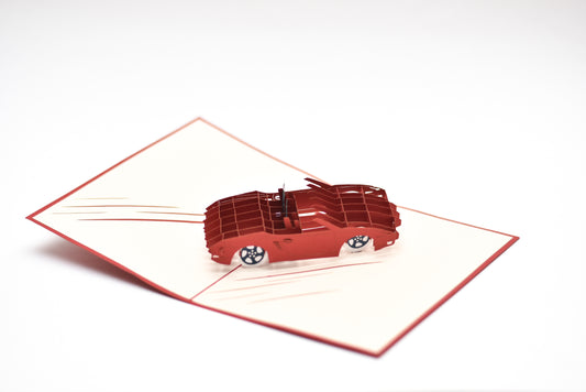 Pop-up card with red convertible car in the middle