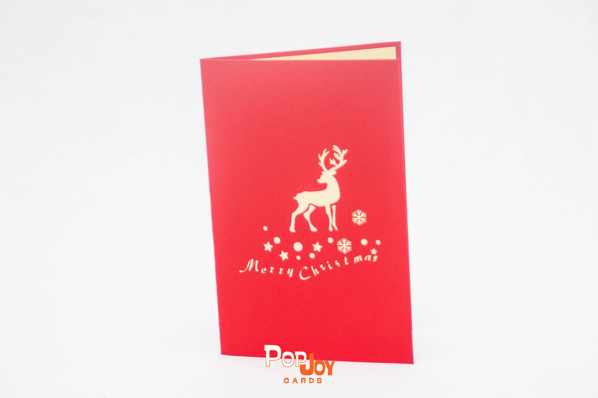 Red card with silhouette of reindeer, snow flakes and Merry Christmas on front cover