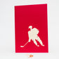 Red card showing silhouette of hockey player with stick in white