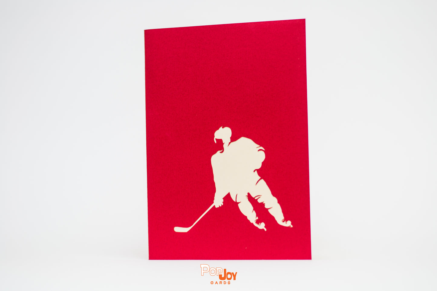 Red card showing silhouette of hockey player with stick in white