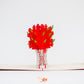 Pop-up card showing red roses in white lace-like vase popping up from card