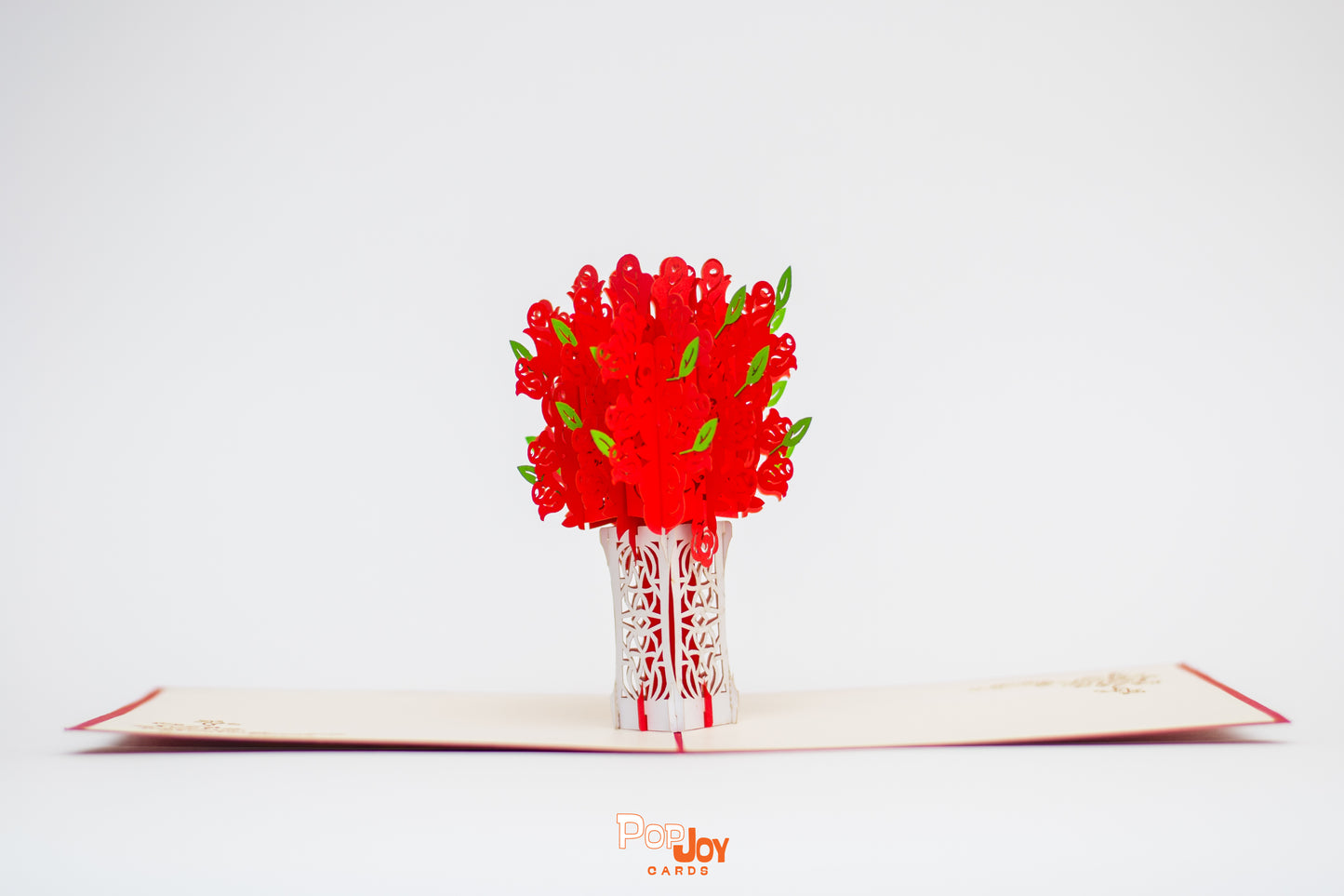 Pop-up card showing red roses in white lace-like vase popping up from card