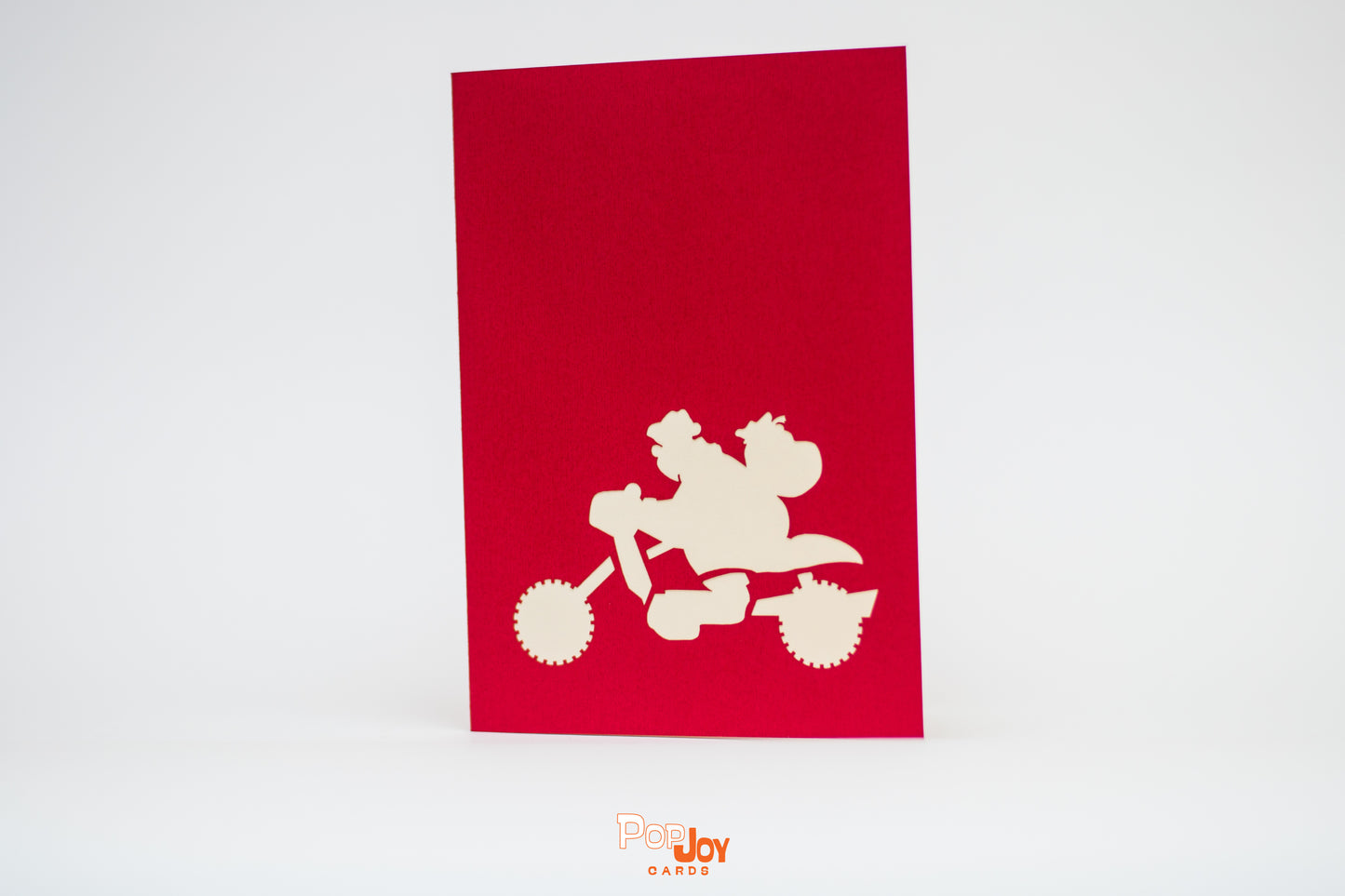 Red card with silhouette of Santa on his motorcycle in white
