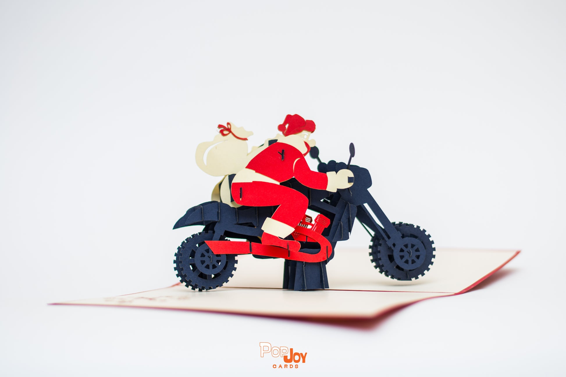 Pop-up card showing Santa riding his motorcycle, with a sack of toys on this back