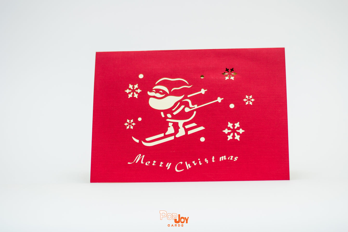 Red card with Santa skiing downhill and the words "merry Christmas"