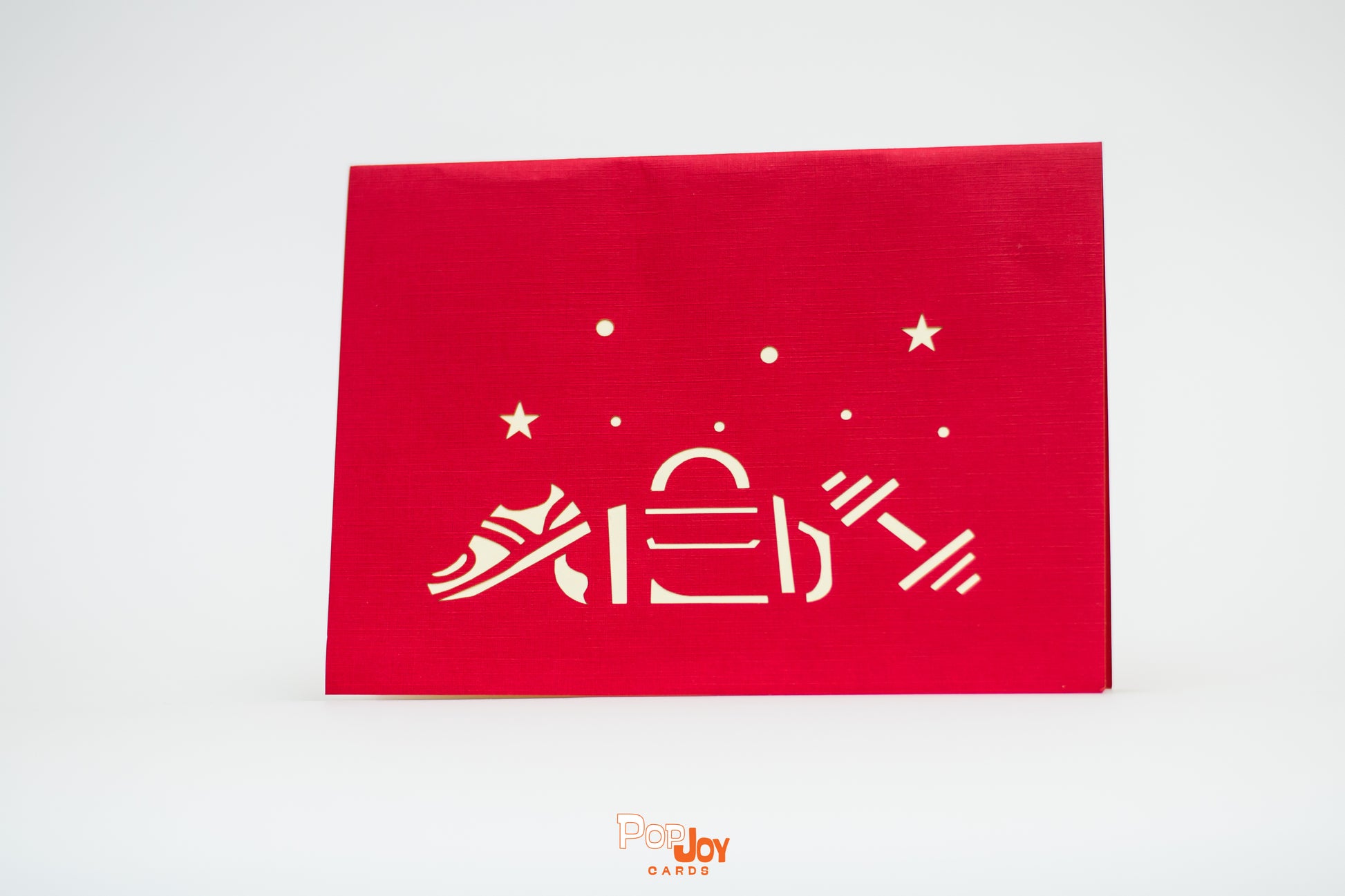 Red card with etching of gym show, gym bag and dumbbell weight in creamy white