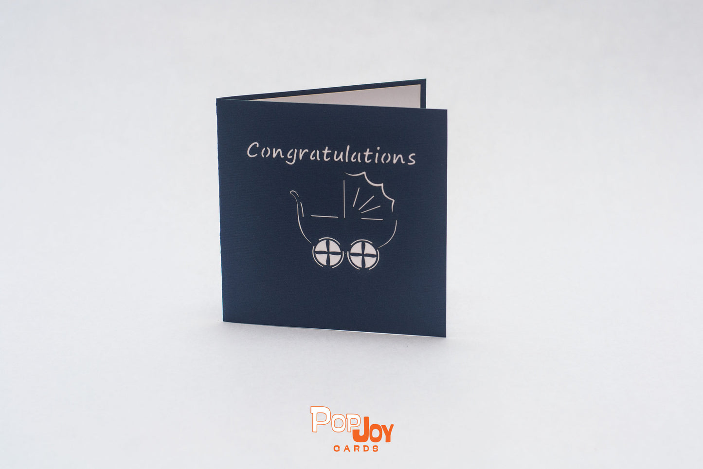 Dark blue card with white outline of stroller and the word "congratulations" on the front cover