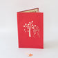 Red card showing cherry blossom tree and couple on wedding day