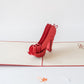 Pop-up card with red heeled shoes in the middle