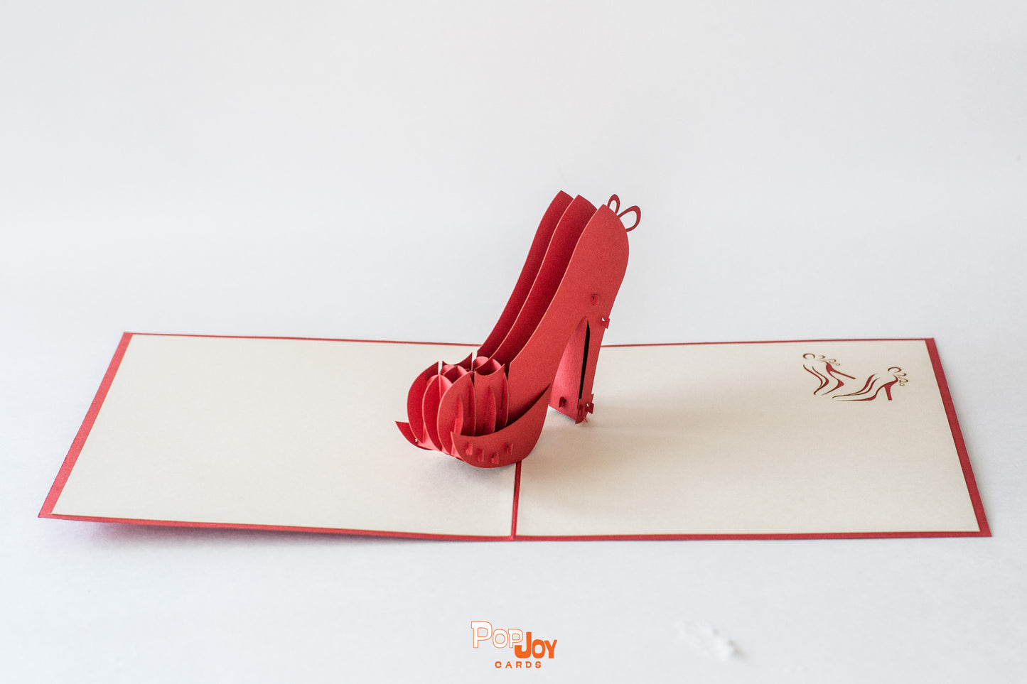Pop-up card with red heeled shoes in the middle