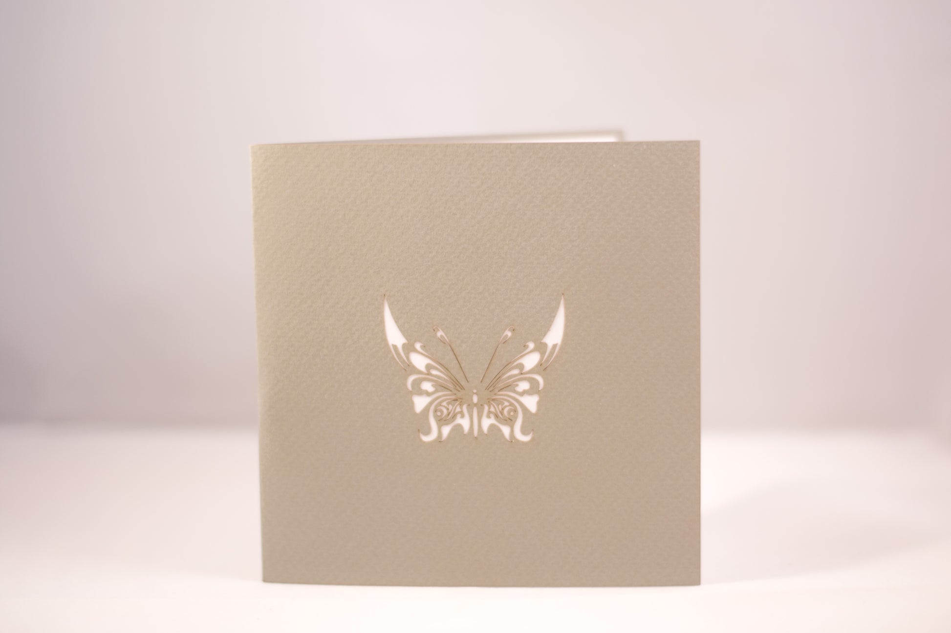 Grey card with butterfly etched in white into front cover